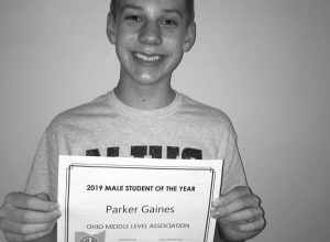 Parker holding his certificate on the day he received the news.
