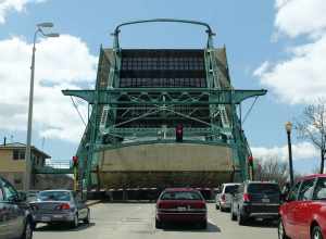 Roadway view of the Cass Street Bridge, in Joliet, Illinois, during an opening of the draw span.  The bridge, which carries westbound US Route 30, is a Scherzer rolling-lift-type bascule bridge.