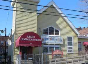 Looking northwest at Iglesia Hermanos Unidos (United Brethren Church) 190 Highland Avenue in the North Ward on a sunny midday.