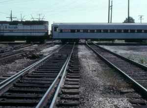 The northbound Hoosier State, running on the ex-Pennsylvania Railroad Bernice Cutoff, crosses the Indiana Harbor Belt Railroad at CP Calumet Park in September 1982. F40PH locomotive #304 is pulling ex-Union Pacific coach #4609 (formerly #4565 and